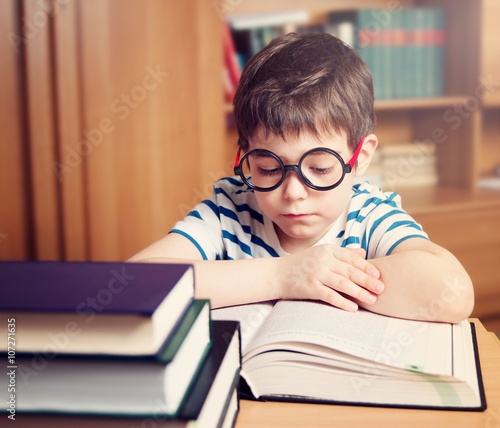 seven years old child reading a book at home