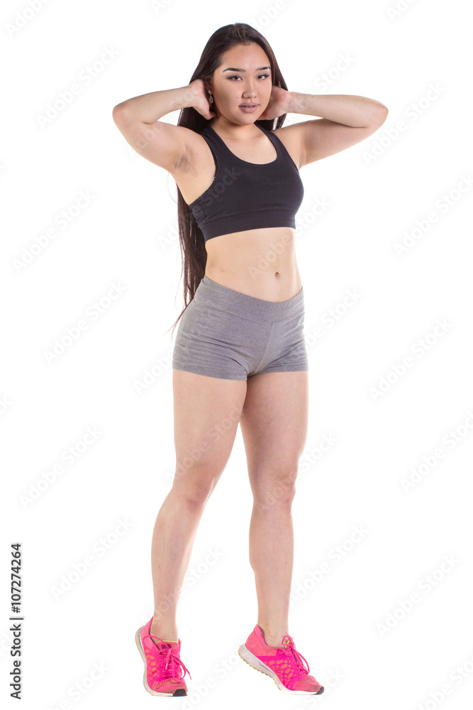Beautiful fitness woman standing - isolated over a white backgro Beautiful fitness woman standing - isolated over a white backgro