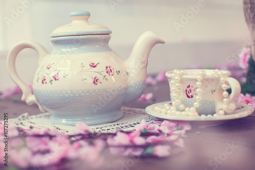 beautiful dishes with flowers tea set, teapot and cup in cherry colors