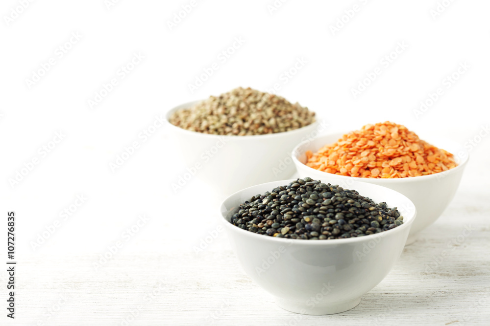 Bowls of assorted dried lentils with red lentils, black beluga l Bowls of assorted dried lentils with red lentils, black beluga l