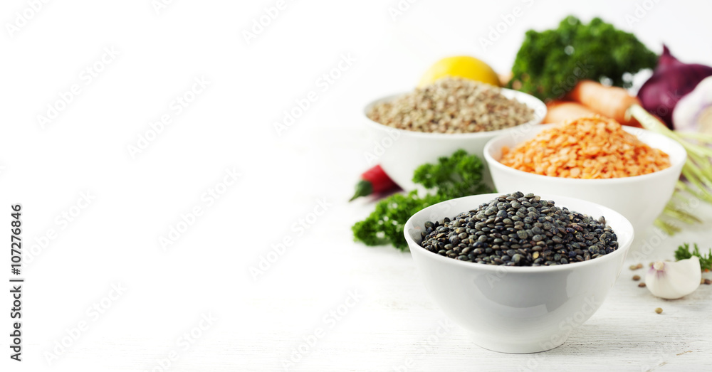 Bowls of assorted dried lentils with vegetables Bowls of assorted dried lentils with vegetables