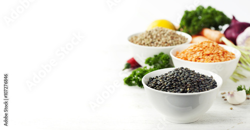 Bowls of assorted dried lentils with vegetables