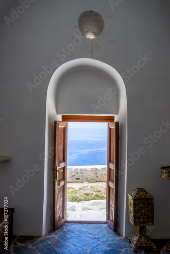 Open door to the sea. Wooden entrance in Mykonos facing the aege photo