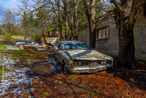 Old, antique car abandoned in a magnificent forrest. © inbulb1