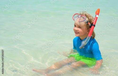 Cute little boy with snorkeling equipment at tropical beach © oksanatrautwein