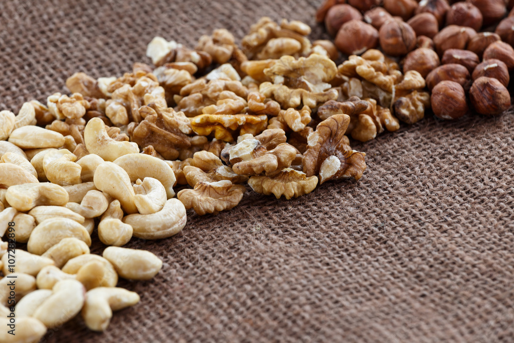 Almonds, cashew, walnuts and hazelnuts lying on burlap Almonds, cashew, walnuts and hazelnuts lying on burlap