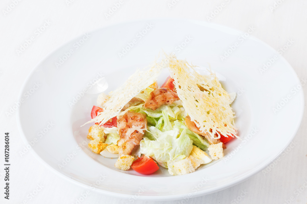 Caesar salad grilled chicken and parmesan crisps plate top white background isolated Caesar salad grilled chicken and parmesan crisps plate top white background isolated