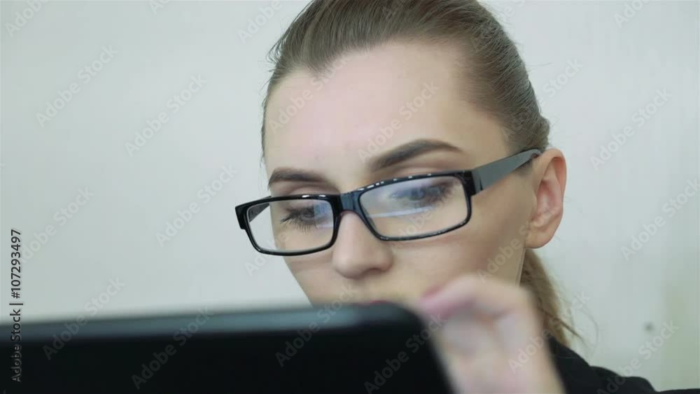 Close-up. Girl works with the tablet Close-up. Girl works with the tablet