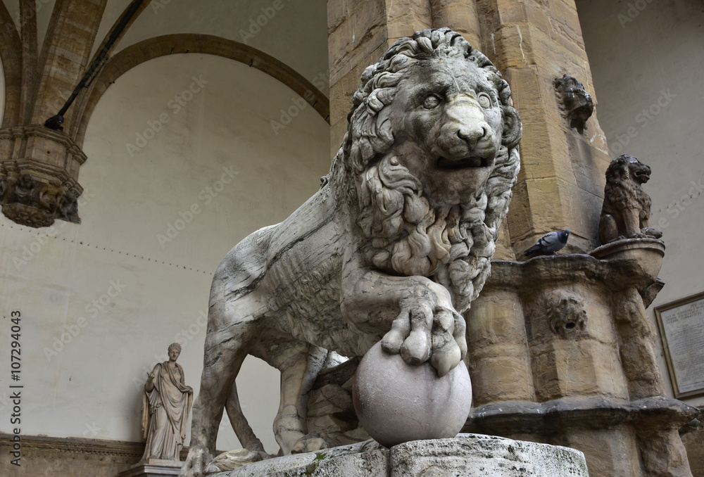 Medici Lion holds the globe in Piazza della Signoria. Marble lion statue at the entrance (right side) of Loggia dei Lanzi in Florence, an ancient roman sculputure from 2nd century