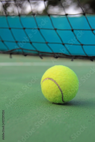 Tennis ball on tennis court © phaitoon