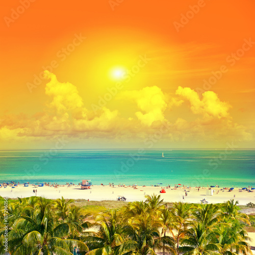 Beautiful sunset. Sky, blue water, palm trees Miami Beach, Ocean