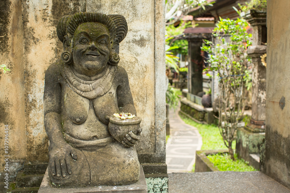 Traditional guard statue carved in stone on Bali, Indonesia.