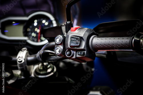 Focus of electric switch on control handle of bike © PPstock