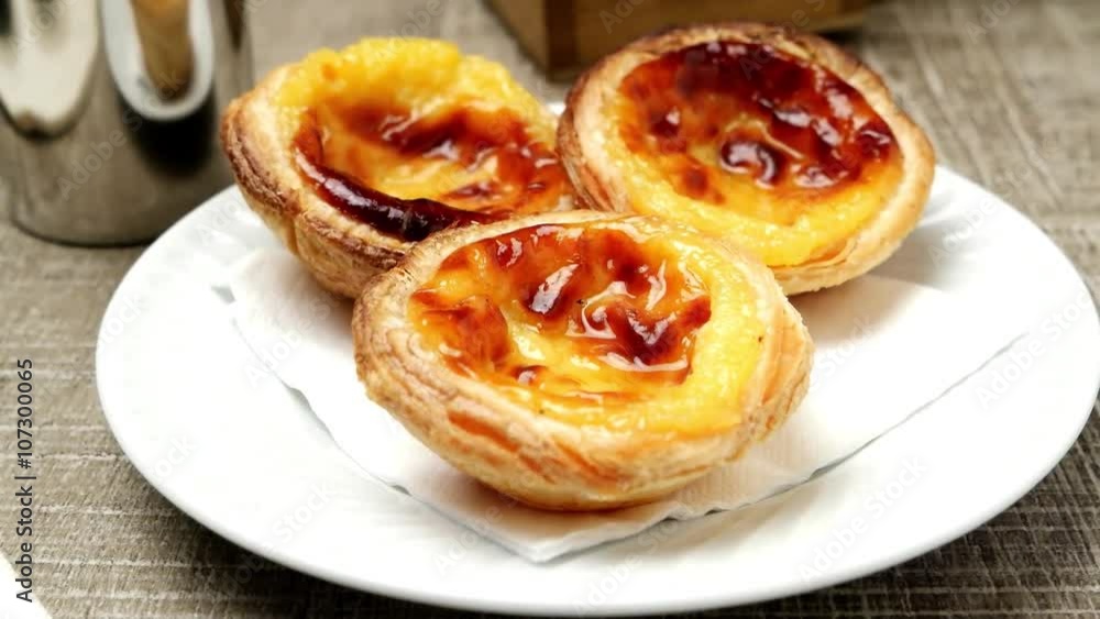 Pasteis de Nata or Portuguese Custard Tarts with black coffee on wooden table. Pasteis de Nata or Portuguese Custard Tarts with black coffee on wooden table.
