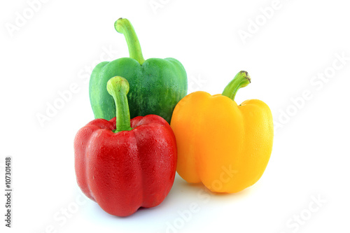 Green Red Yellow paprika peppers with water drops isolated on white background