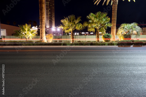 Photography empty asphalt road near modern skyscraper at night in las vegas