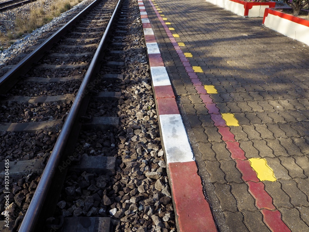 Railroad and Red, yellow and white lines on sidewalks in Thailand
