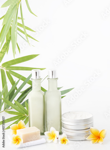 Cosmetic products on the white background with bamboo leaves