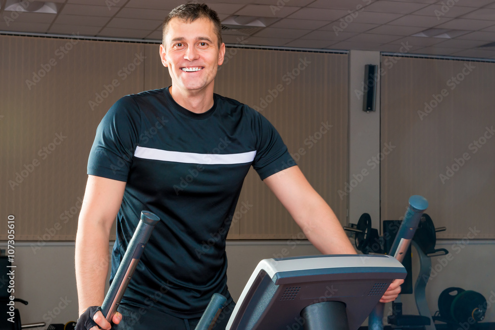 a handsome man in a gym at workout a handsome man in a gym at workout