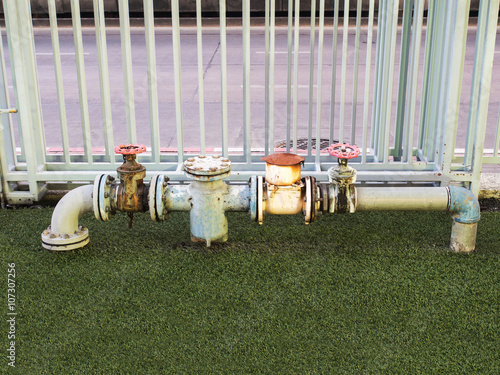 old metal rusty industrial tap water pipe and valve