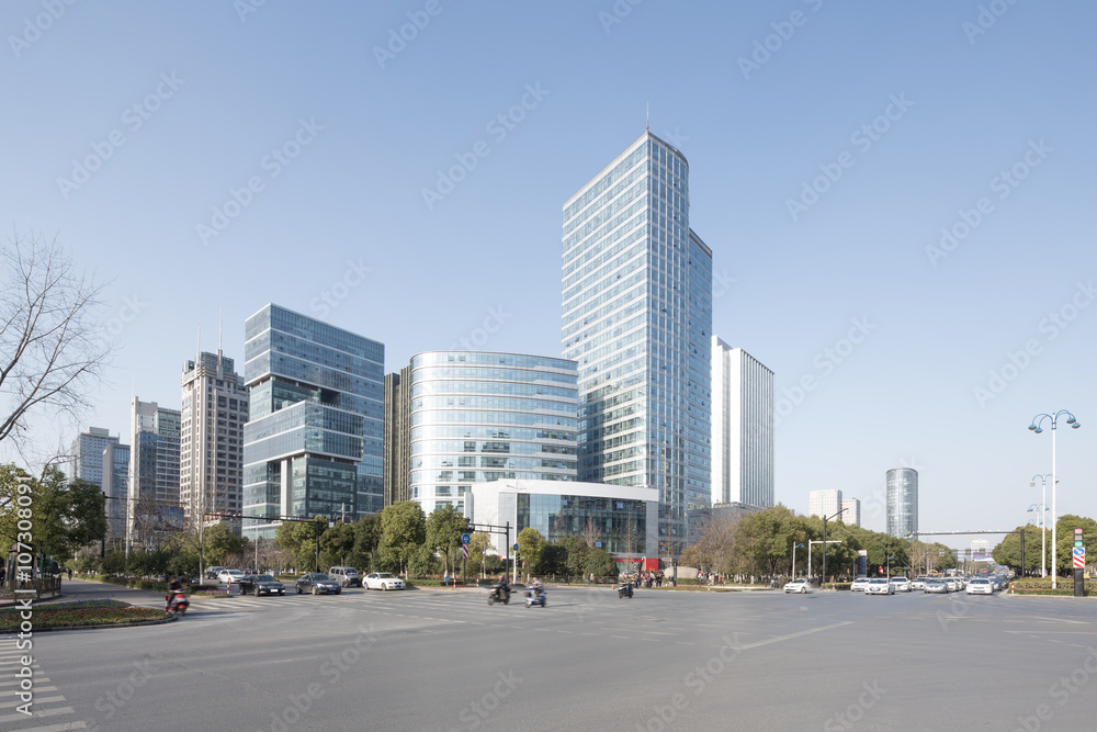 traffic on road intersection near modern buildings and skyline o traffic on road intersection near modern buildings and skyline o
