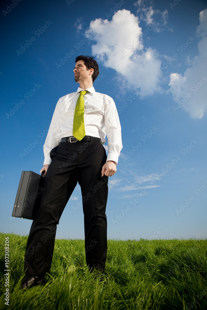 happy businessman with suitcase outdoor in a sunny day