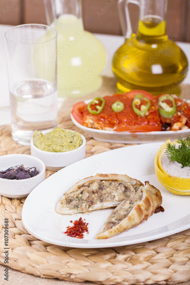 Plate of stuffed cuttlefish inside cheese, mushroom and seafood serving with aubergine salad Plate of stuffed cuttlefish inside cheese, mushroom and seafood serving with aubergine salad