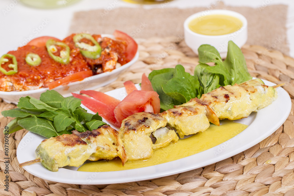 Whiting Fish Skewer on White Plate with Salad and Turkish Traditional Alcohol Drink Raki , Ouzo
