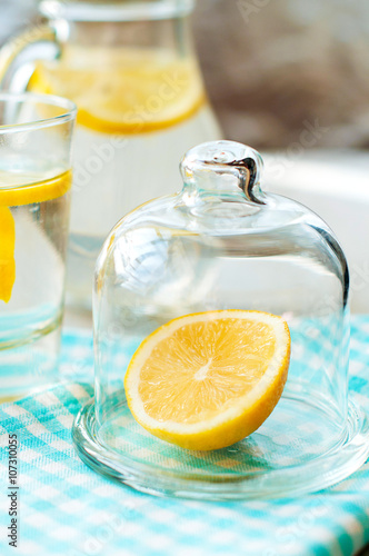 sliced lemon with a glass of water