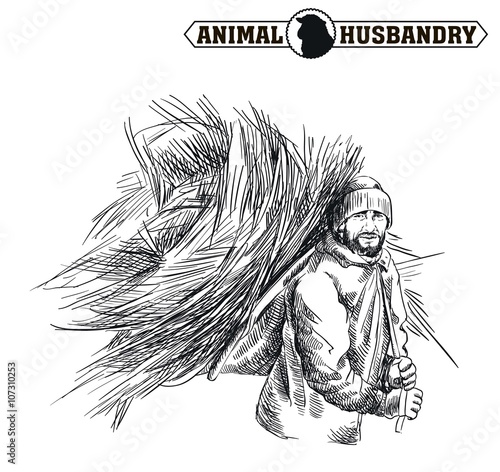 farmer with an armful of hay behind