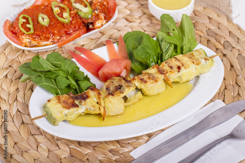 Whiting Fish Skewer on White Plate with Salad and Turkish Traditional Alcohol Drink Raki , Ouzo