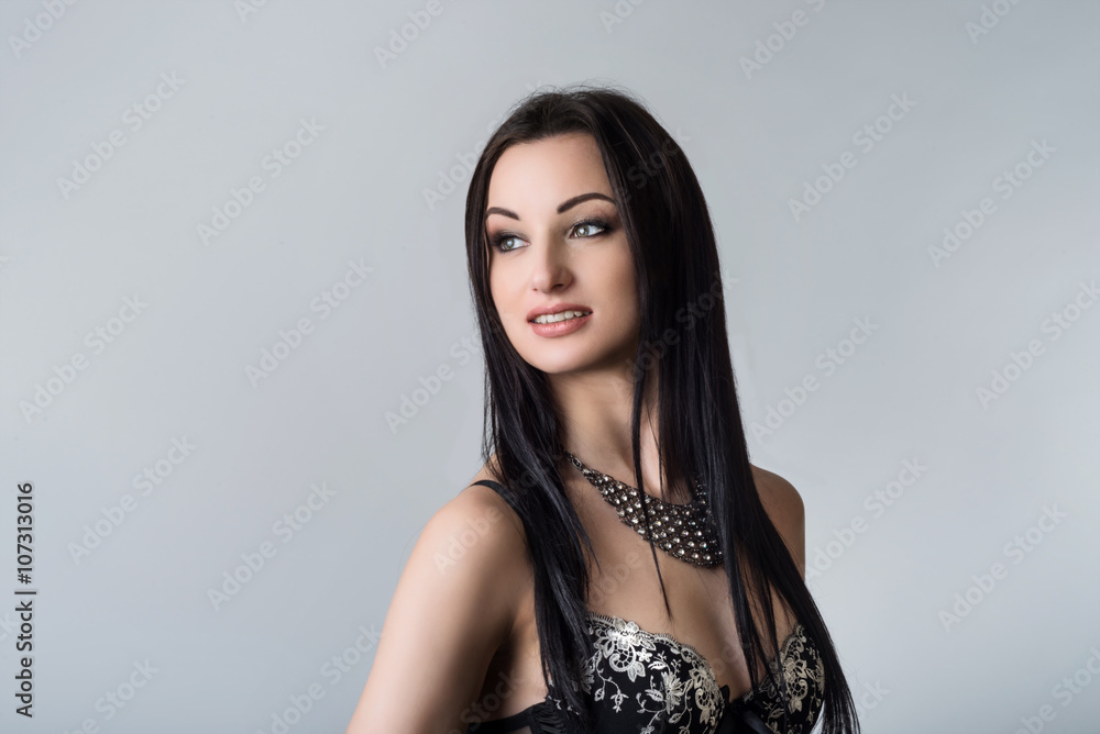 Gorgeous brunette portrait on grey background Gorgeous brunette portrait on grey background