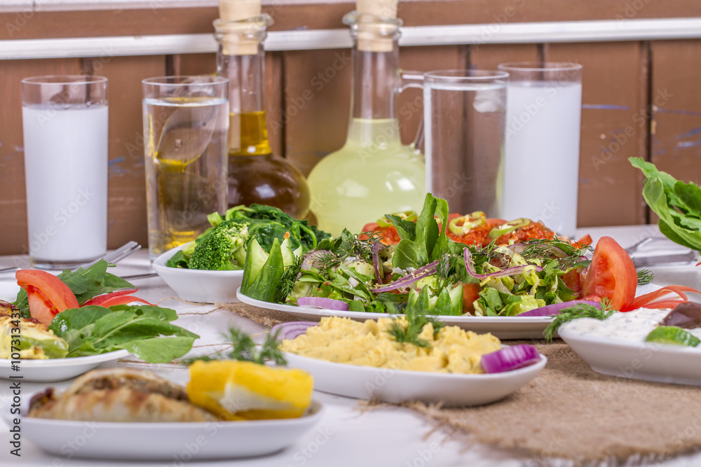 Turkish and Greek traditional rustic dinner table with raki, ouzo Turkish and Greek traditional rustic dinner table with raki, ouzo