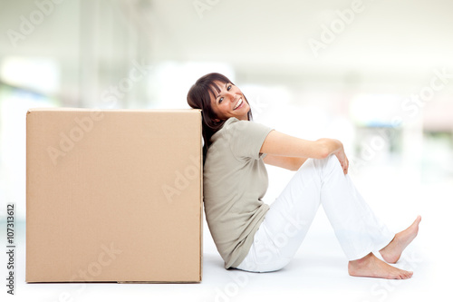 beautiful young girl hold a box in a interior background