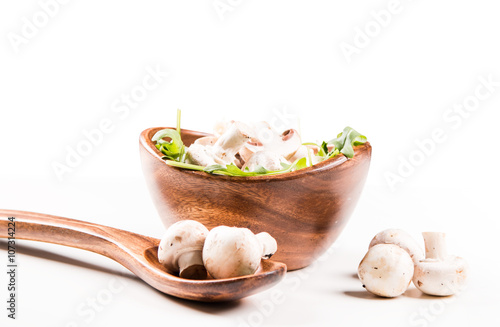 Fresh mushrooms champignons in bowl isolated on white