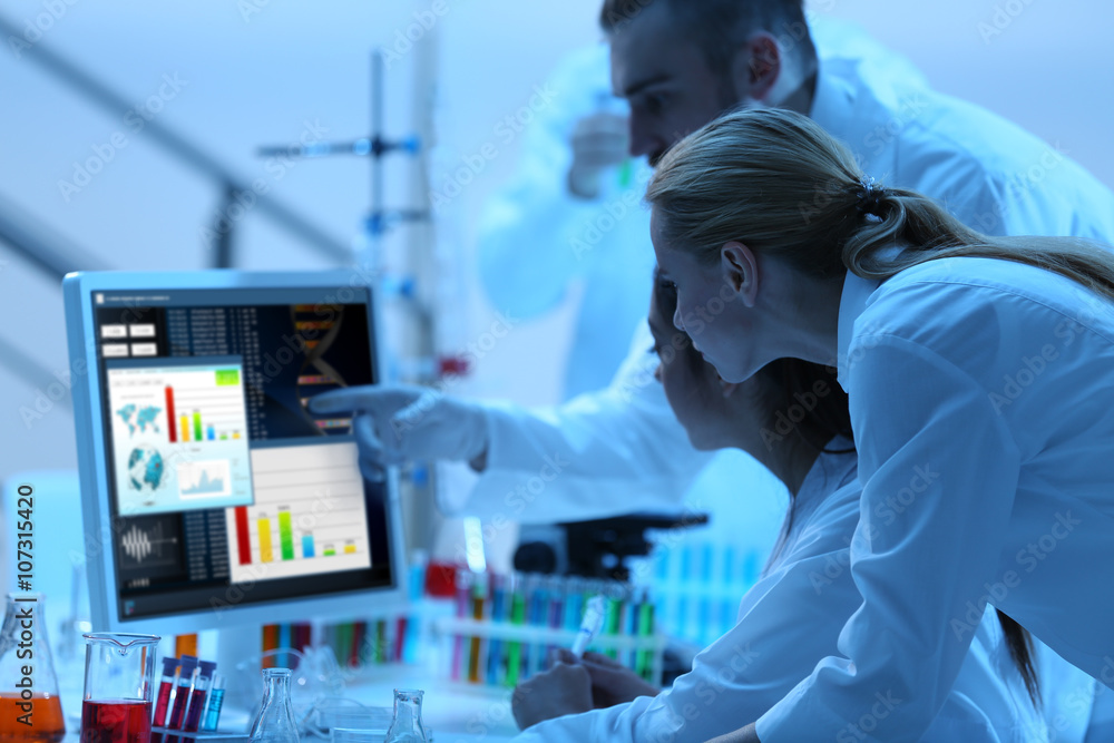 Young medical technicians working in laboratory Young medical technicians working in laboratory