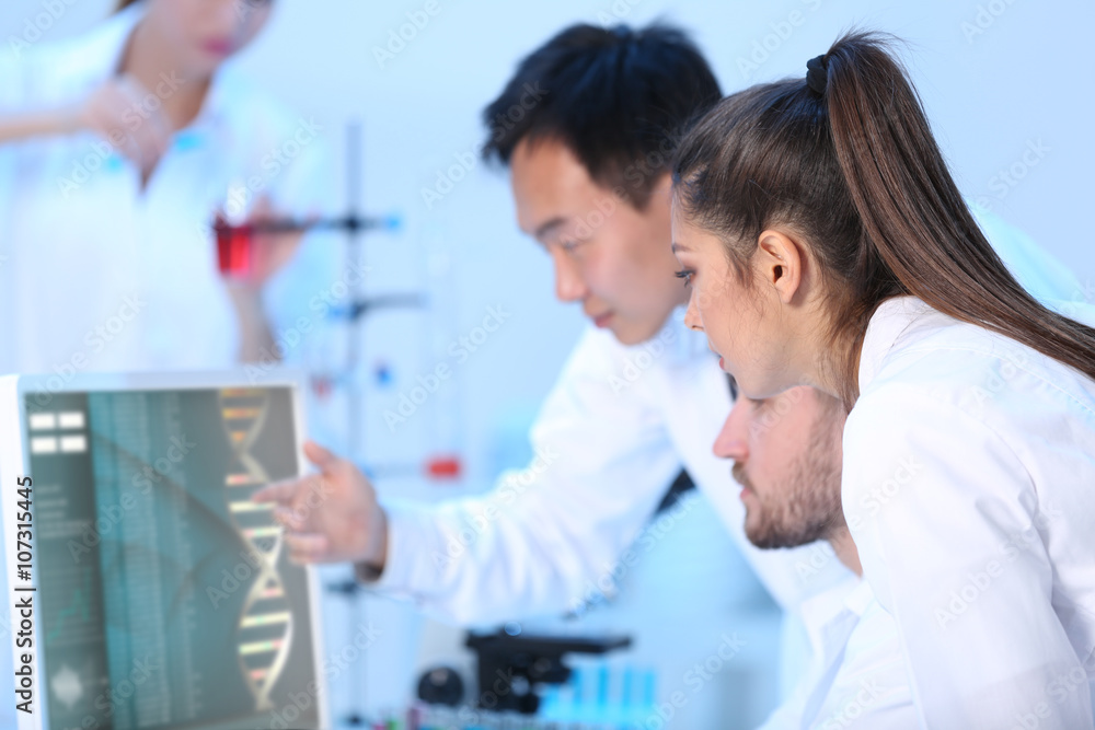 Young medical technicians working in laboratory Young medical technicians working in laboratory