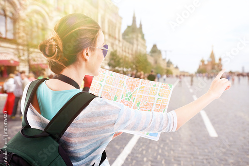 Traveler with map on the st...