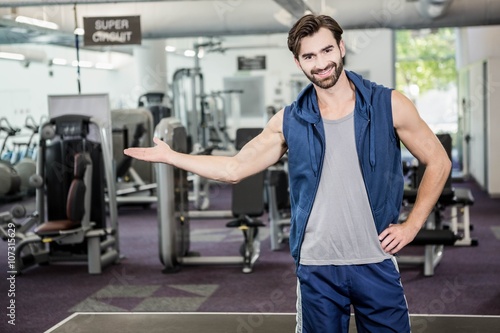 Smiling man showing the gym