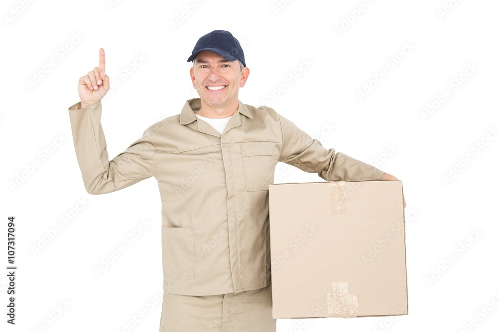 Delivery man carrying a package and pointing Delivery man carrying a package and pointing