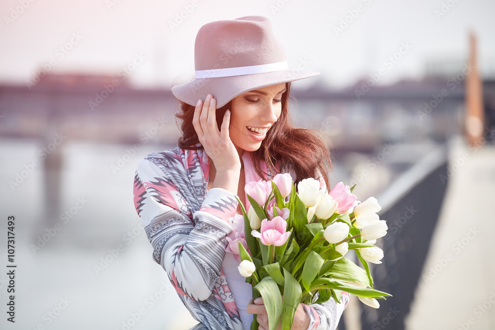 beautiful girl holds color tulips