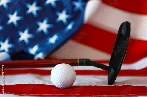 Golf ball and club on background of American flag. Popular sport concept