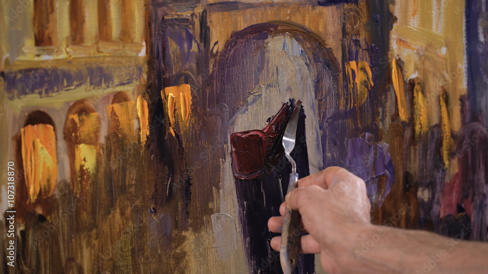 Obraz premium An artist painting with a palette knife in studio