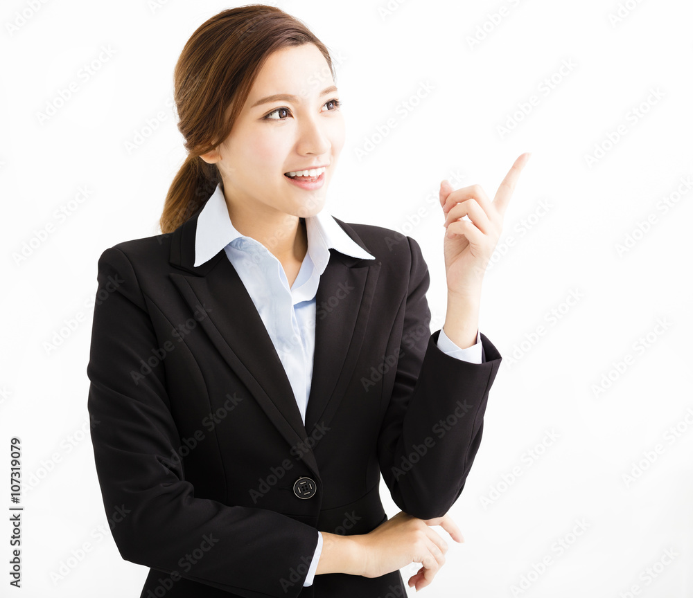 Beautiful young business woman pointing and looking Beautiful young business woman pointing and looking