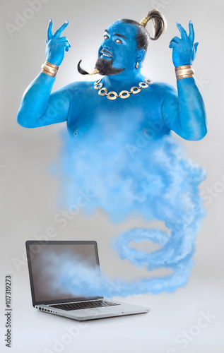 genie of the lamp with smoke from laptop isolated on grey photo