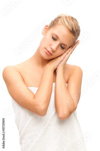 beautiful blonde woman sleep on his hand covered with towel isolated on white