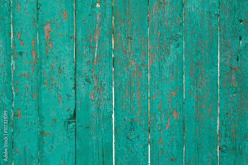 Old green cracked paint on the old wooden background