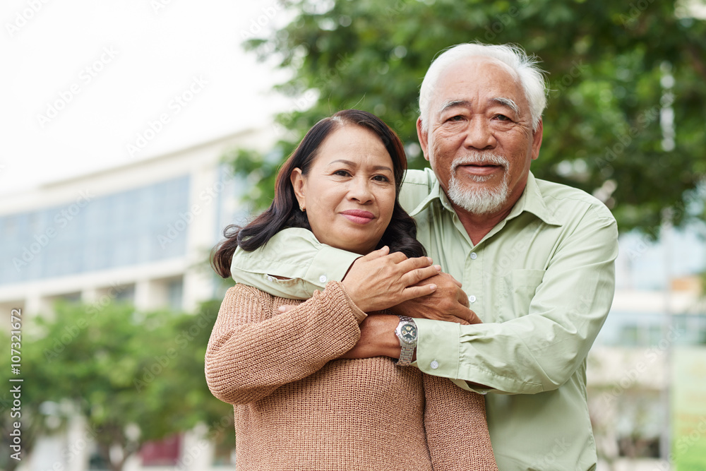 Portrait of hugging senior Vietnamese couple Portrait of hugging senior Vietnamese couple