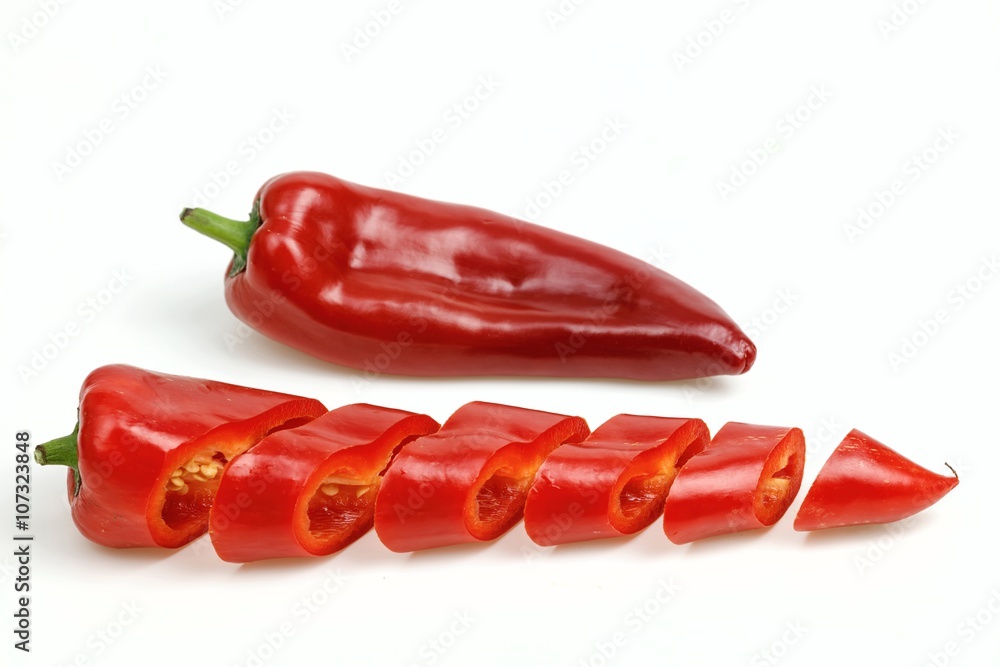 Pointy red pepper and one cut into pieces, on white background. Pointy red pepper and one cut into pieces, on white background.