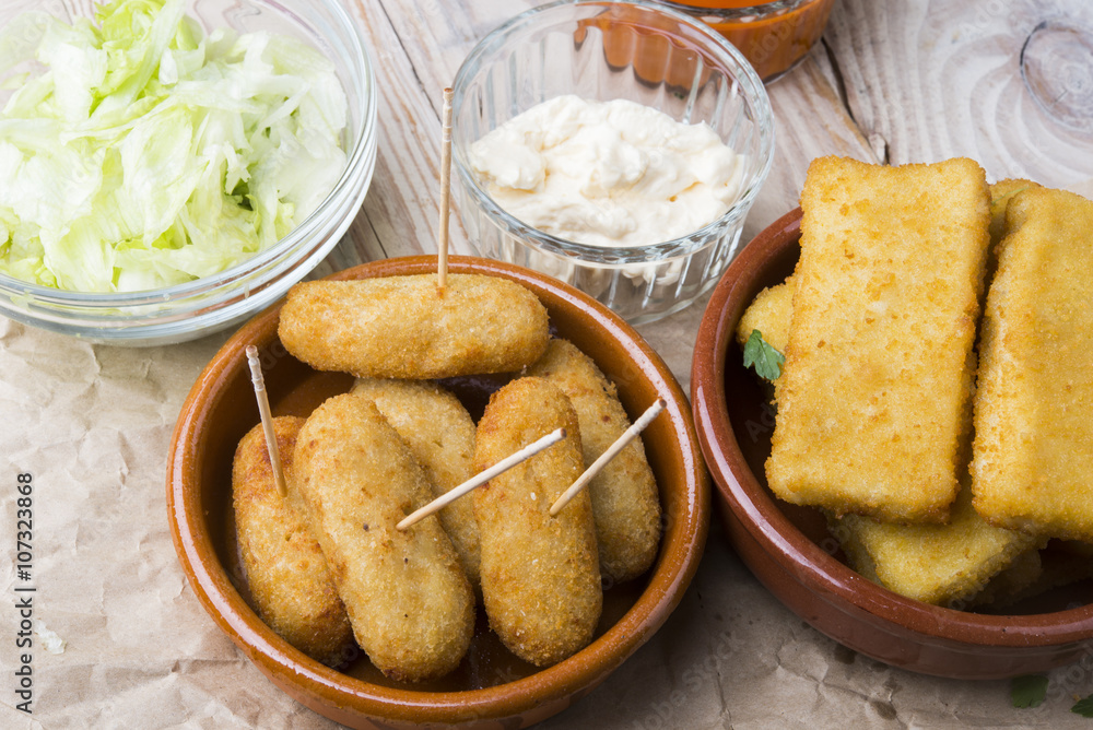 croquettes balls and different kind of sauces on a plate on a cl croquettes balls and different kind of sauces on a plate on a cl